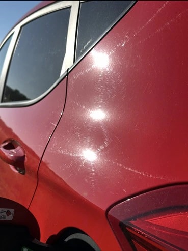 Avant : carrosserie rouge d’une Ford Fiesta ST Line couverte de micro-rayures